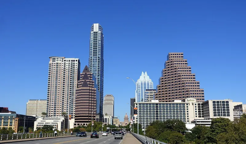 Downtown Austin skyline with high-rise towers under a blue sky