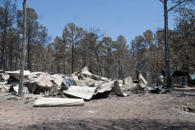 Collapsed remains of a home destroyed by the Bastrop County Complex wildfire in Texas