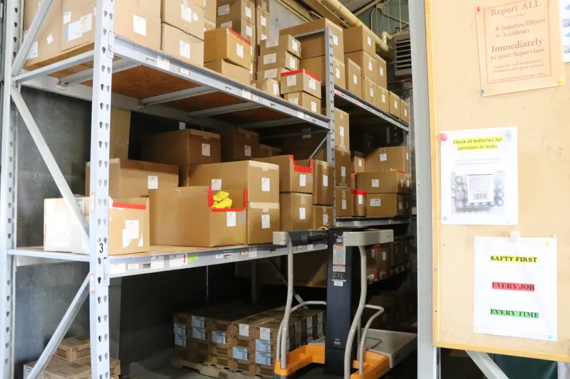 Warehouse interior with metal pallet racking stacked with cardboard boxes